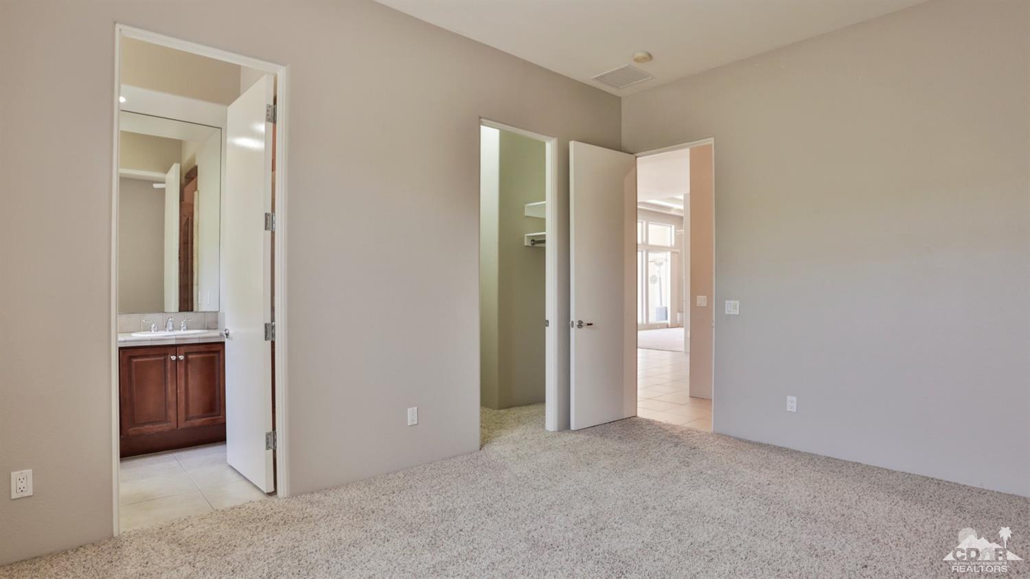 5 University Circle Rancho Mirage, CA 92270 - Photo 36 of 60 an empty room with closet and wooden door