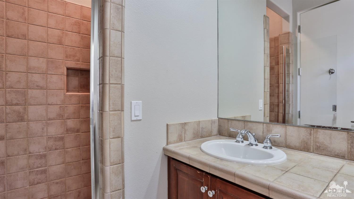 5 University Circle Rancho Mirage, CA 92270 - Photo 41 of 60 a bathroom with a sink and a mirror