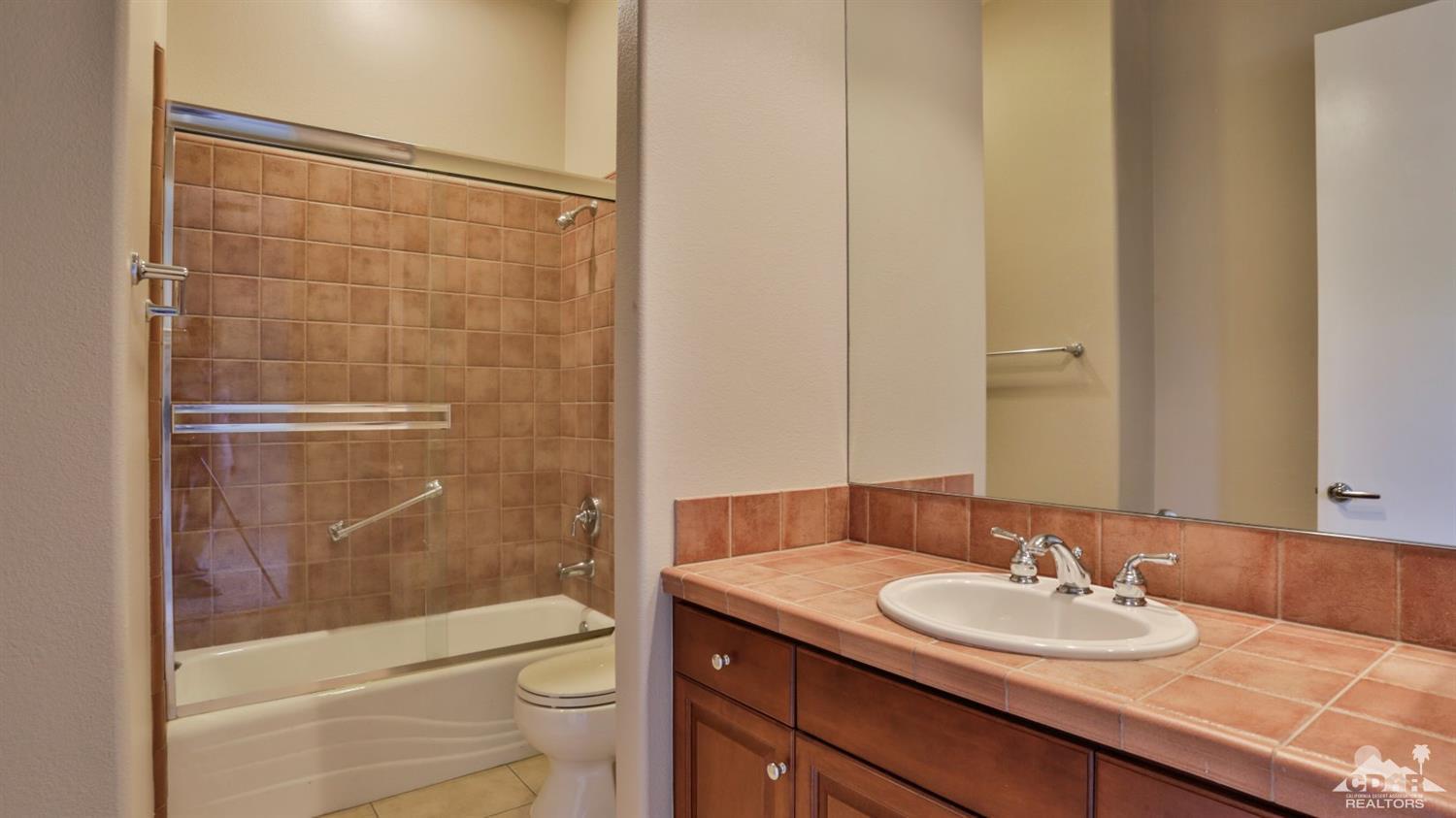 5 University Circle Rancho Mirage, CA 92270 - Photo 43 of 60 a bathroom with a sink a toilet and shower