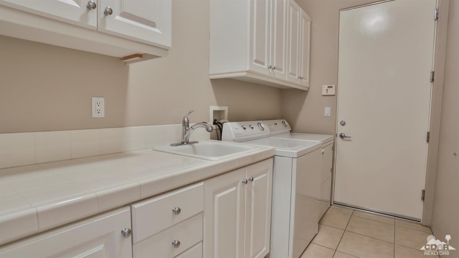 5 University Circle Rancho Mirage, CA 92270 - Photo 44 of 60 a sink with white cabinets