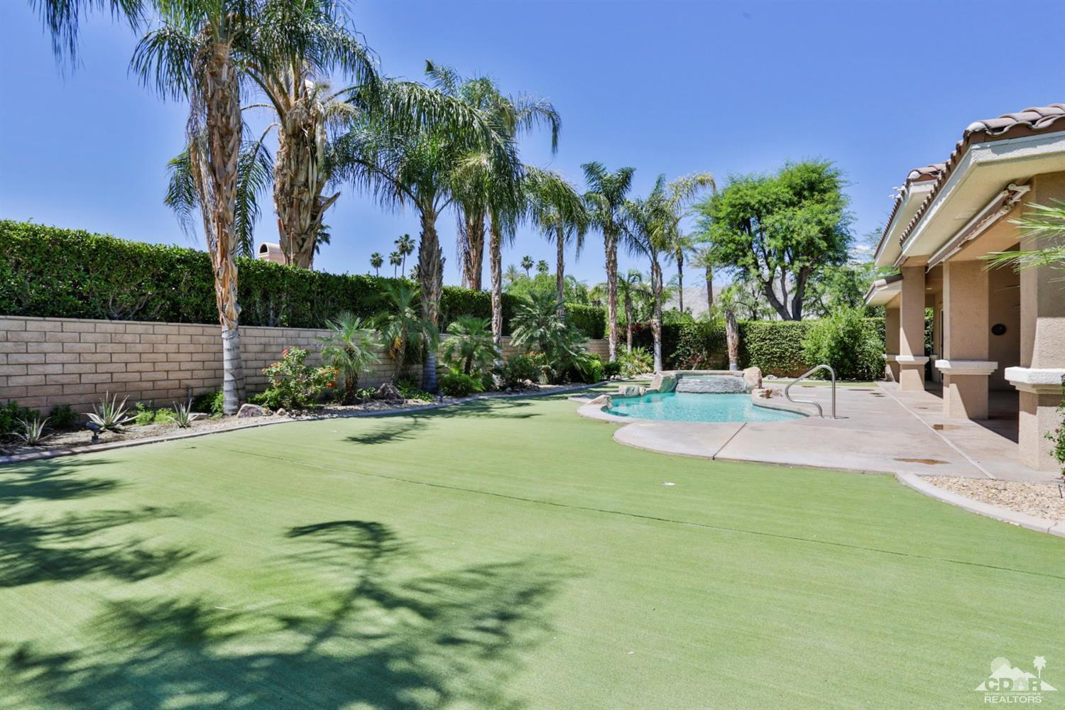 5 University Circle Rancho Mirage, CA 92270 - Photo 47 of 60 a view of a swimming pool with palm trees