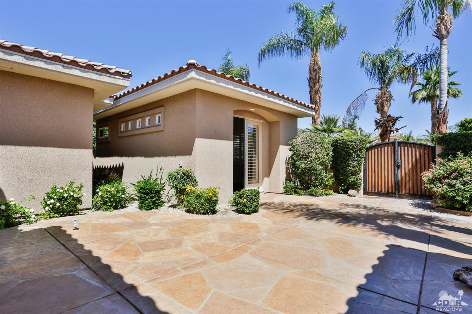 5 University Circle Rancho Mirage, CA 92270 - Photo 49 of 60 a view of a house with a yard and potted plants