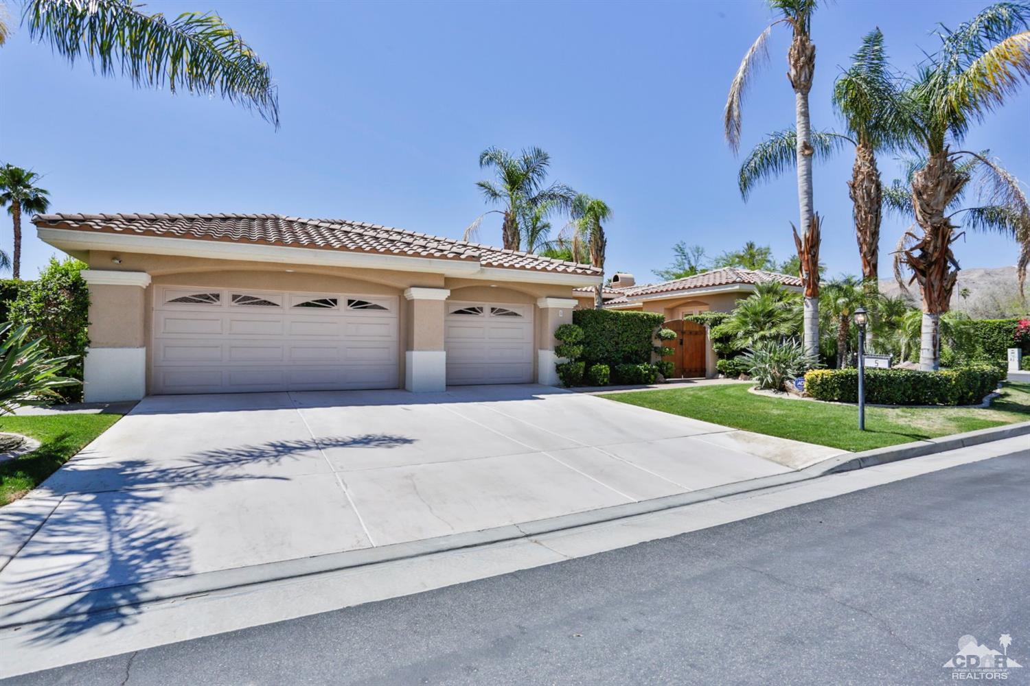 5 University Circle Rancho Mirage, CA 92270 - Photo 59 of 60 a front view of a house with a yard and garage