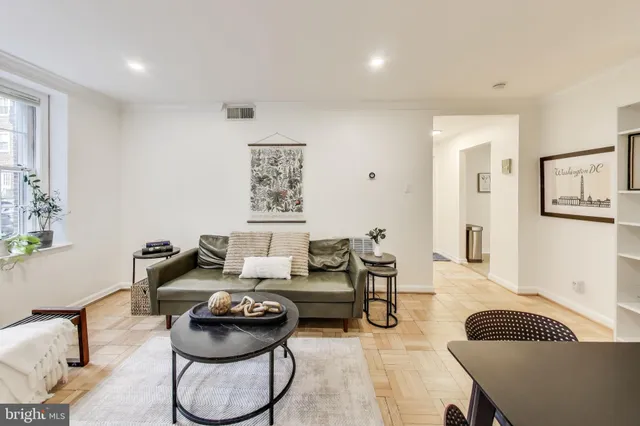 a living room with furniture and a rug
