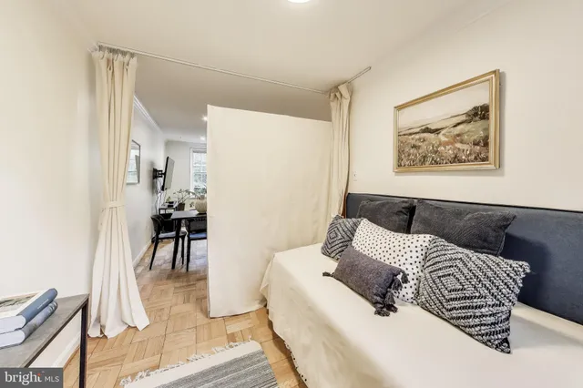 a bedroom with a bed and a painting on the wall