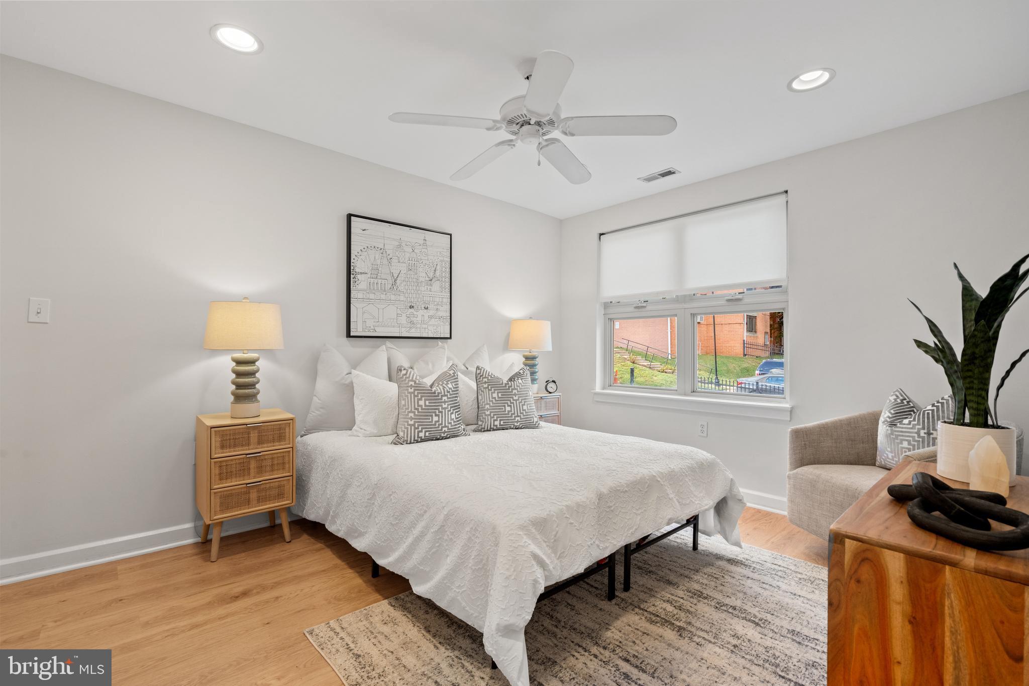 1421 Chapin Street Northwest, Unit 102 Washington, DC 20009 - Photo 4 of 37 a bedroom with a bed and a potted plant
