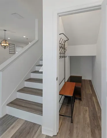 a view of entryway and hall with wooden floor