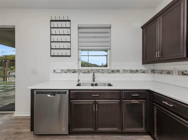 a kitchen with a sink and a mirror