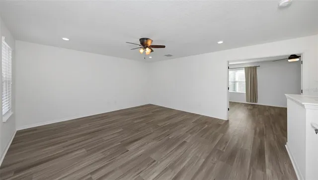 a bathroom with a granite countertop toilet sink and mirror