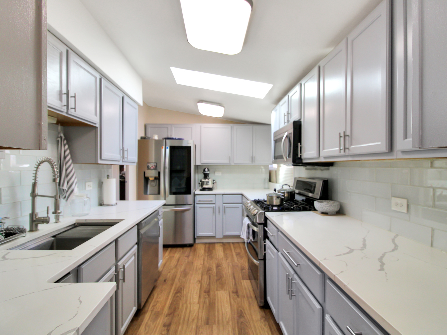 7806 80th Place Bridgeview, IL 60455 - Photo 3 of 16 a kitchen with a sink a stove and cabinets