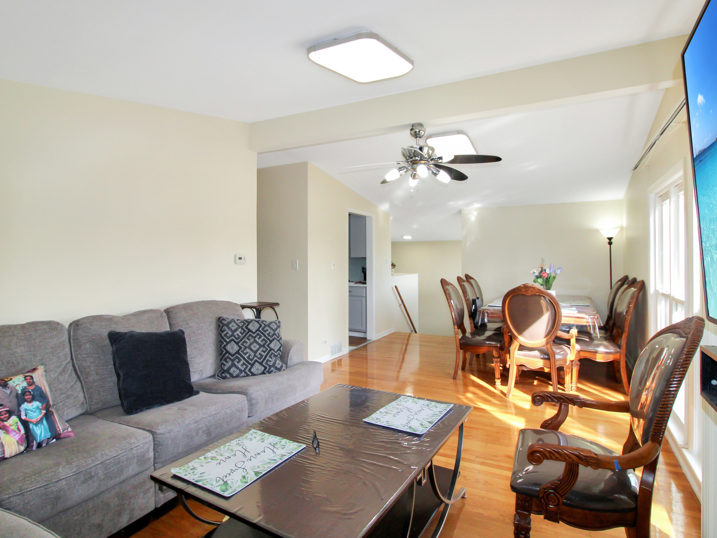 7806 80th Place Bridgeview, IL 60455 - Photo 6 of 16 a living room with furniture a chandelier and a dining table
