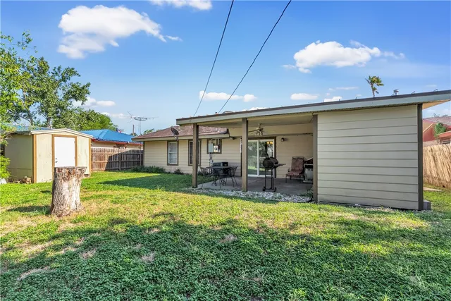 a view of a house with a yard and sitting area