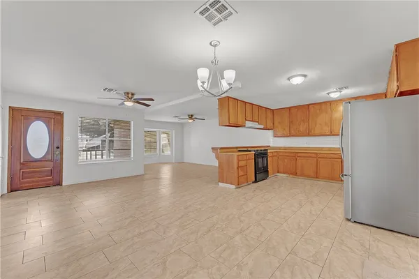 a view of a kitchen with microwave and cabinets