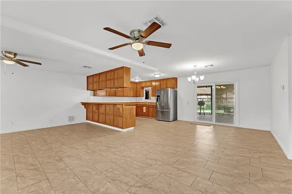 a view of a livingroom with a ceiling fan and window