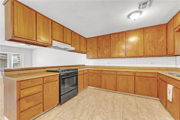 a kitchen with cabinets appliances and a sink