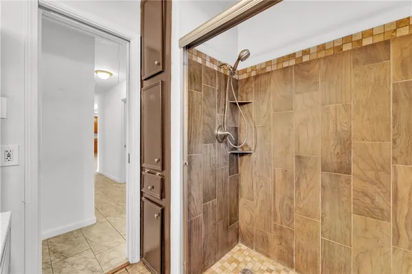 a bathroom with a shower and a glass door