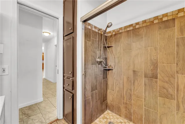 a bathroom with a shower and a glass door