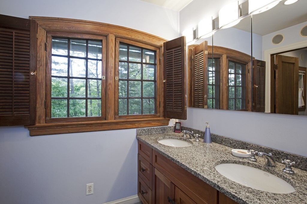 162 Waban Avenue Newton, MA 02468 - Photo 22 of 24 a bathroom with a granite countertop sink and a large mirror