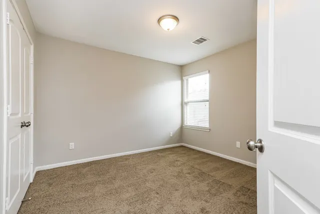 an empty room with a empty space and windows