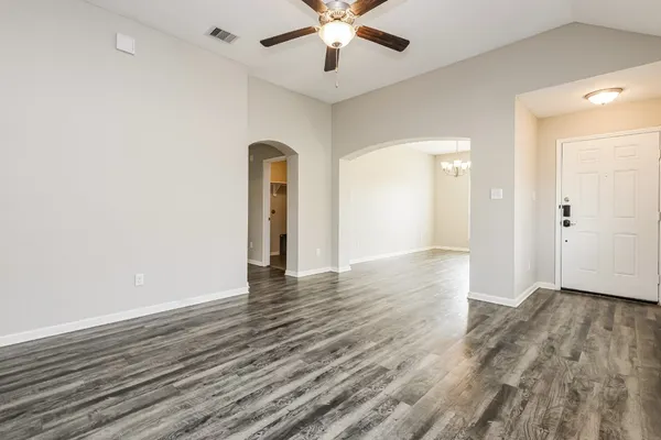 wooden floor in an empty room with a window
