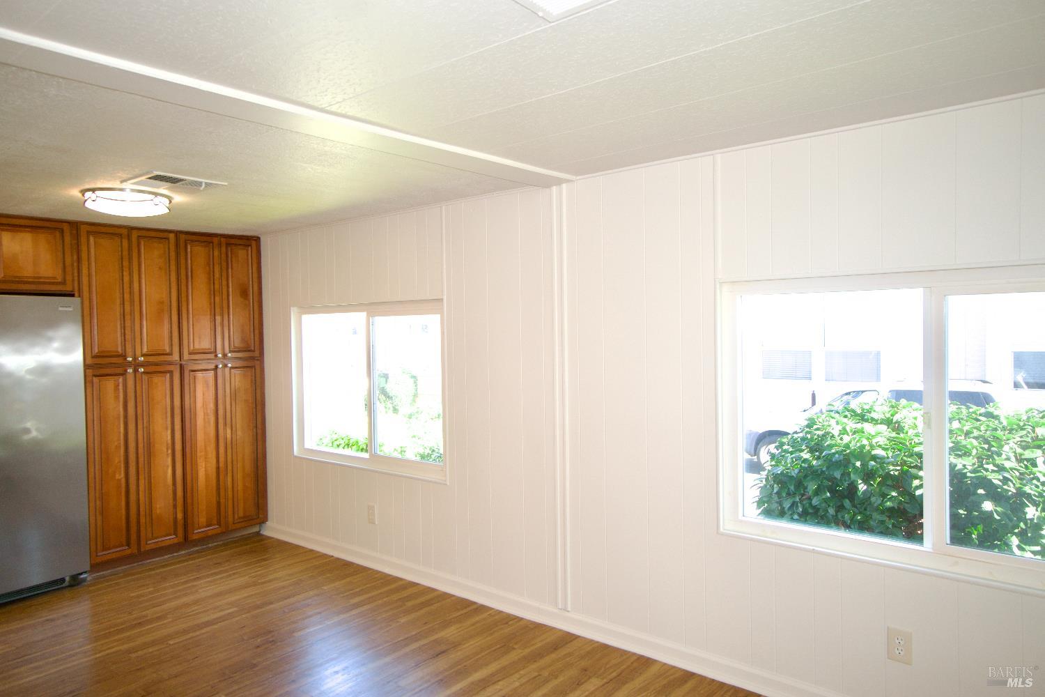 2412 Foothill Boulevard, Unit 124 Calistoga, CA 94515 - Photo 12 of 49 a view of an empty room with wooden floor and a window