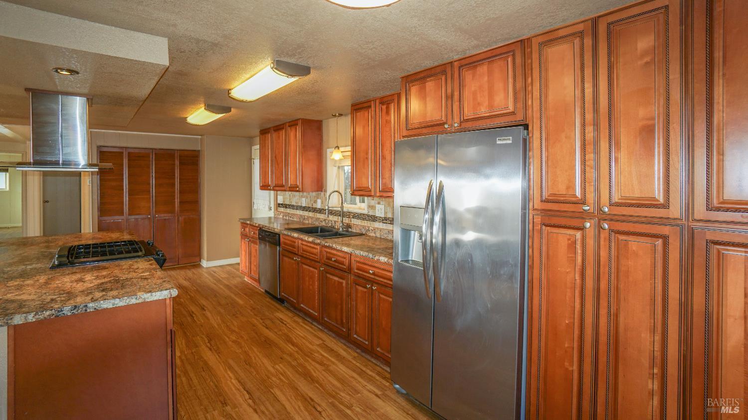2412 Foothill Boulevard, Unit 124 Calistoga, CA 94515 - Photo 19 of 49 a kitchen with stainless steel appliances granite countertop a refrigerator a stove and a sink
