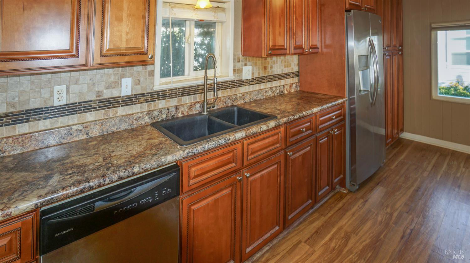 2412 Foothill Boulevard, Unit 124 Calistoga, CA 94515 - Photo 21 of 49 a kitchen with granite countertop a sink stove and cabinets