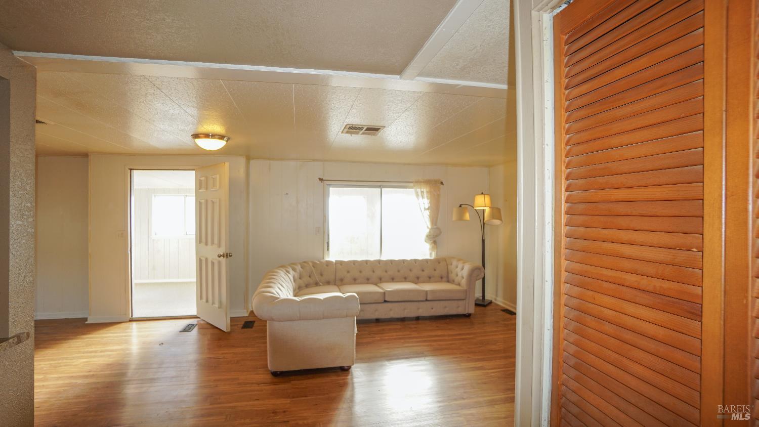 2412 Foothill Boulevard, Unit 124 Calistoga, CA 94515 - Photo 22 of 49 a living room with furniture and a gate