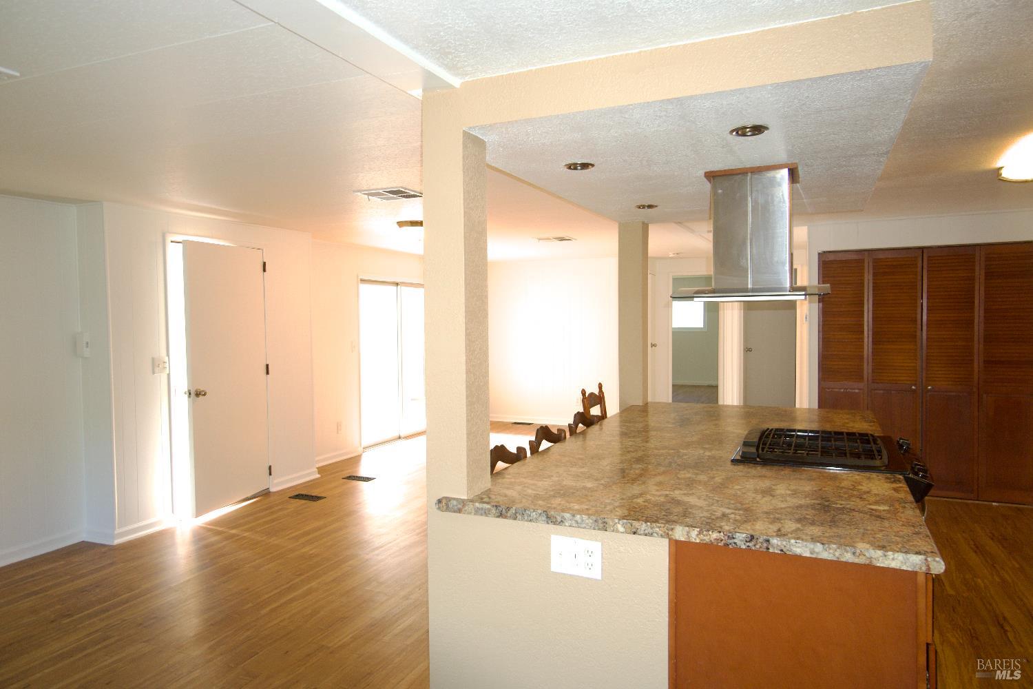 2412 Foothill Boulevard, Unit 124 Calistoga, CA 94515 - Photo 23 of 49 a view of a kitchen with granite countertop a sink and a refrigerator