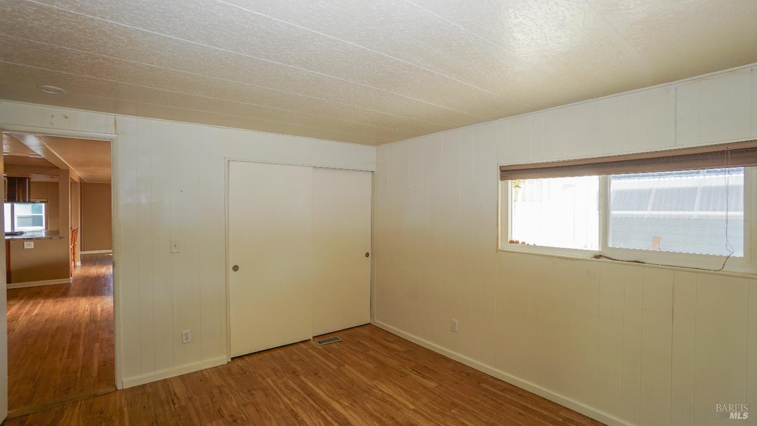 2412 Foothill Boulevard, Unit 124 Calistoga, CA 94515 - Photo 36 of 49 an empty room with wooden floor and windows