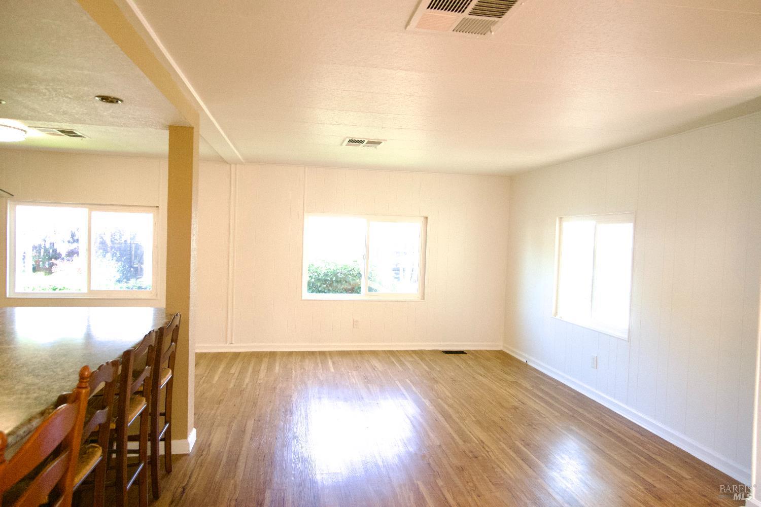 2412 Foothill Boulevard, Unit 124 Calistoga, CA 94515 - Photo 44 of 49 a view of an empty room with wooden floor and a window