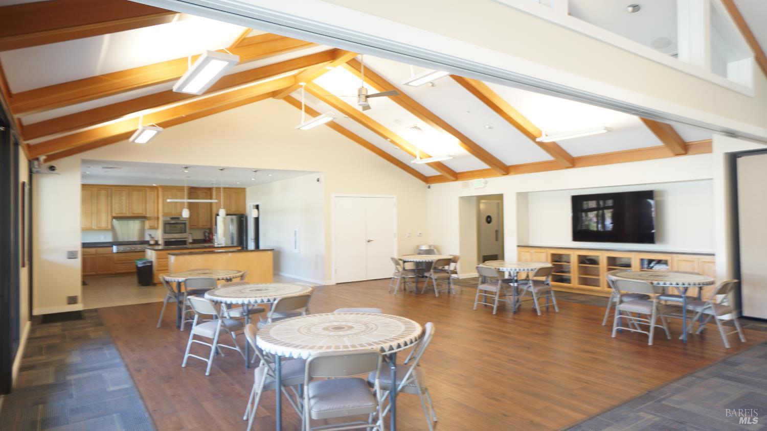 2412 Foothill Boulevard, Unit 124 Calistoga, CA 94515 - Photo 46 of 49 a dining room with wooden floor a glass table and chairs