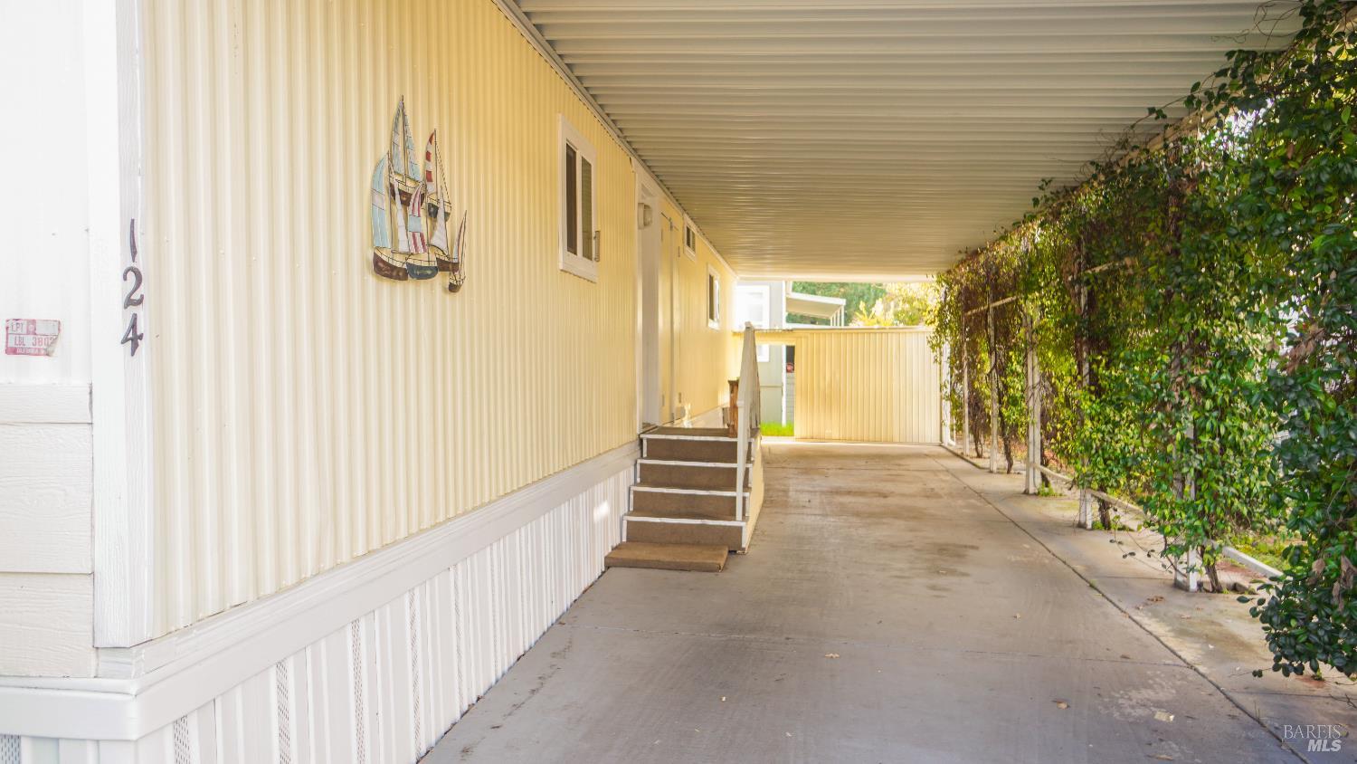 2412 Foothill Boulevard, Unit 124 Calistoga, CA 94515 - Photo 5 of 49 a view of a pathway of a house with wooden fence