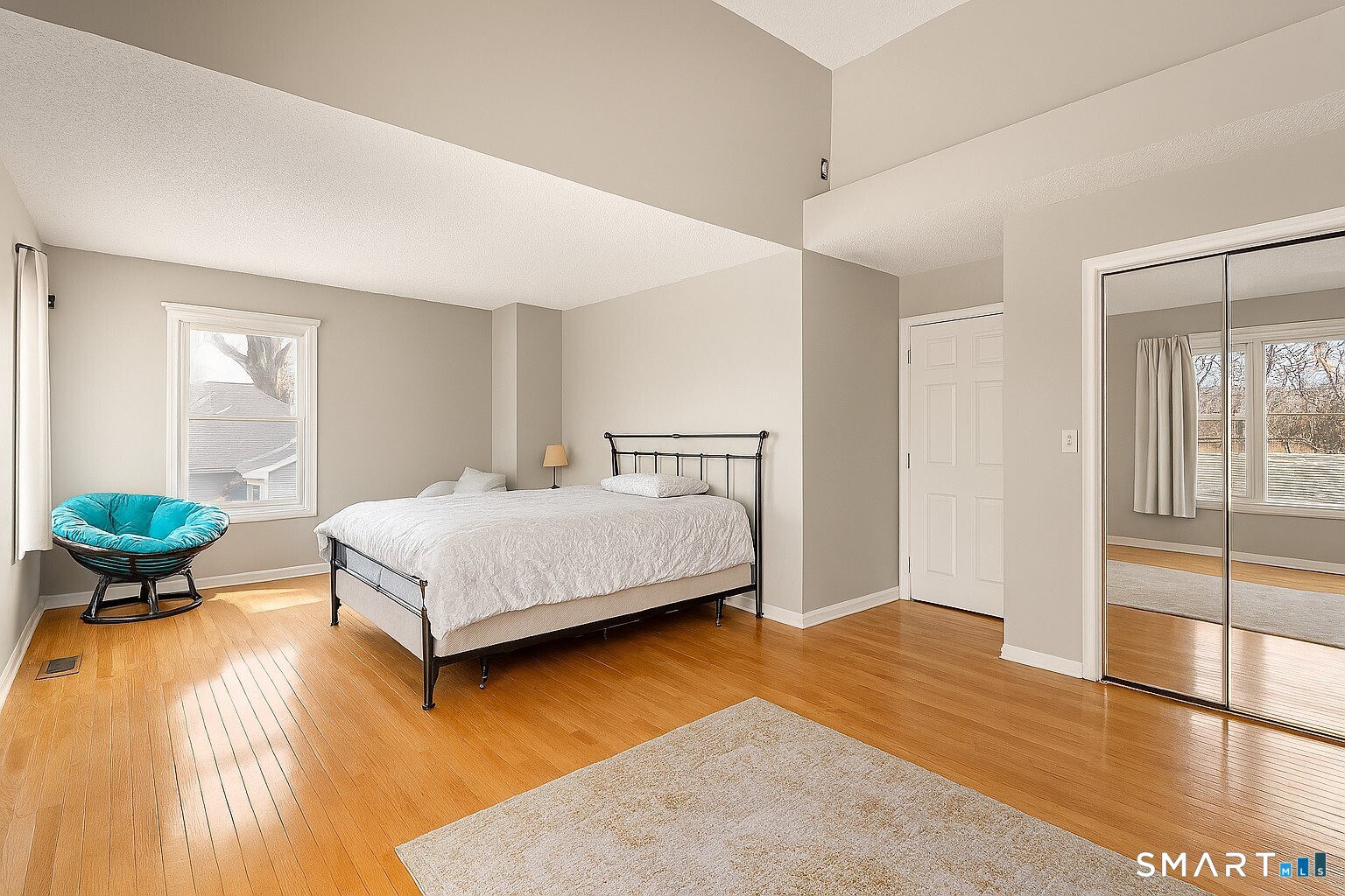 175 South End Road, Unit B10 East Haven, CT 06512 - Photo 18 of 32 a bedroom with a bed and wooden floor
