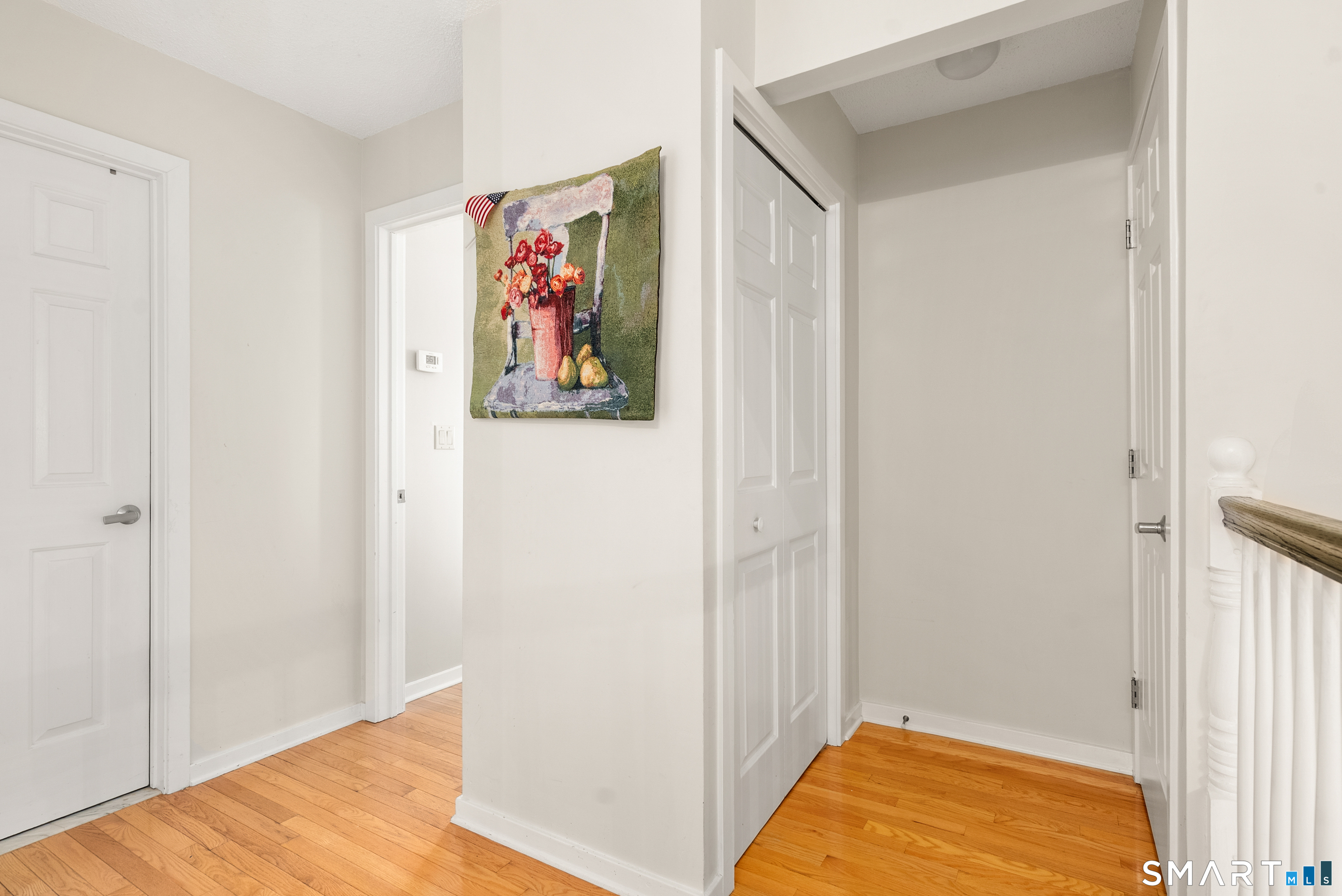 175 South End Road, Unit B10 East Haven, CT 06512 - Photo 22 of 32 a view of a hallway with paintings on the wall