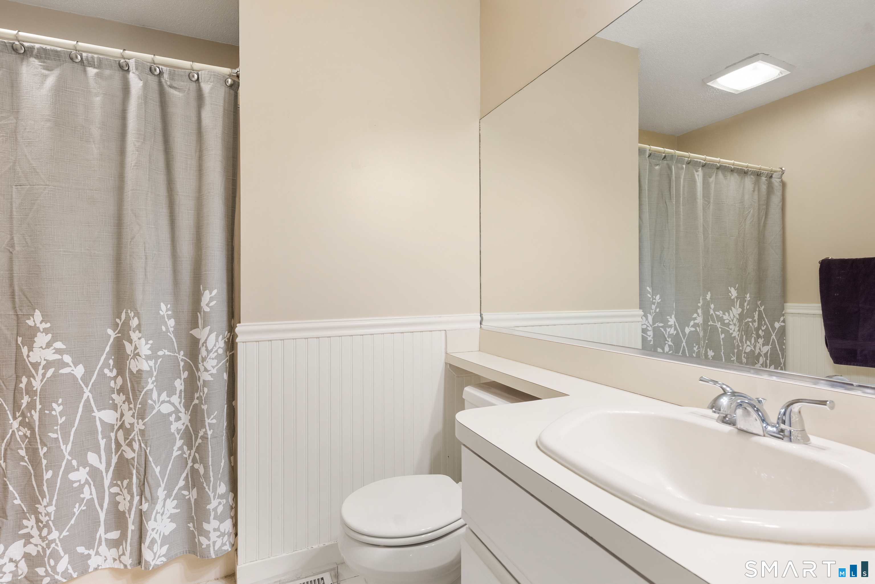 175 South End Road, Unit B10 East Haven, CT 06512 - Photo 24 of 32 a bathroom with a sink a toilet a mirror and shower curtain