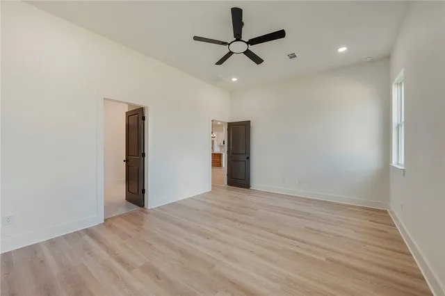 a kitchen with stainless steel appliances granite countertop a sink a stove and a wooden floors
