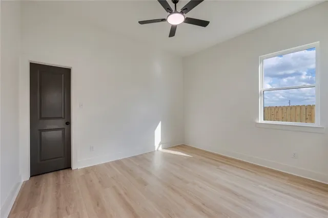 wooden floor in an empty room with a window