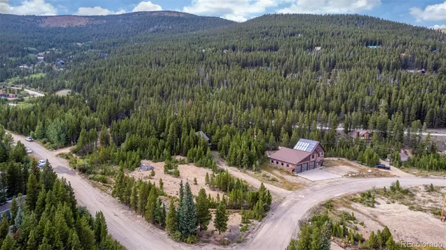 a view of a house with a yard and garden