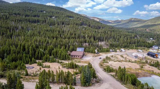 a view of a lake in middle of the forest