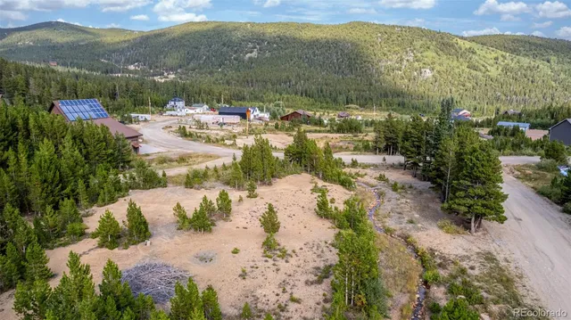 a view of a lush green hillside and a houses