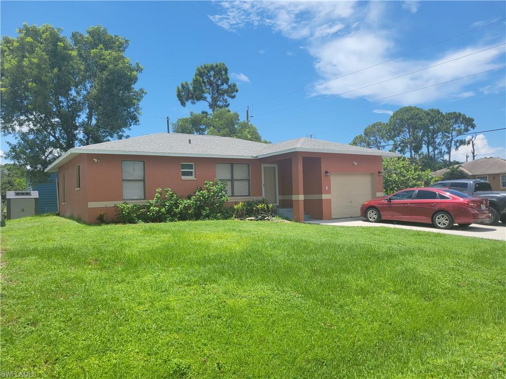 8518 Morris Road Fort Myers, FL 33967 - Photo 1 of 18 a front view of house with yard and green space