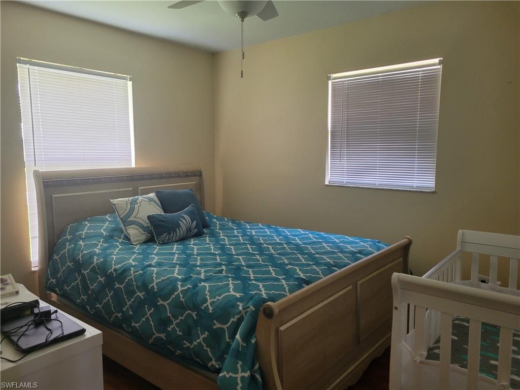 8518 Morris Road Fort Myers, FL 33967 - Photo 14 of 18 a bed sitting in a bedroom next to a window