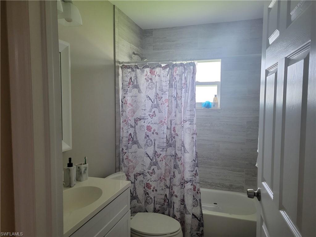 8518 Morris Road Fort Myers, FL 33967 - Photo 15 of 18 a bathroom with a sink toilet and shower