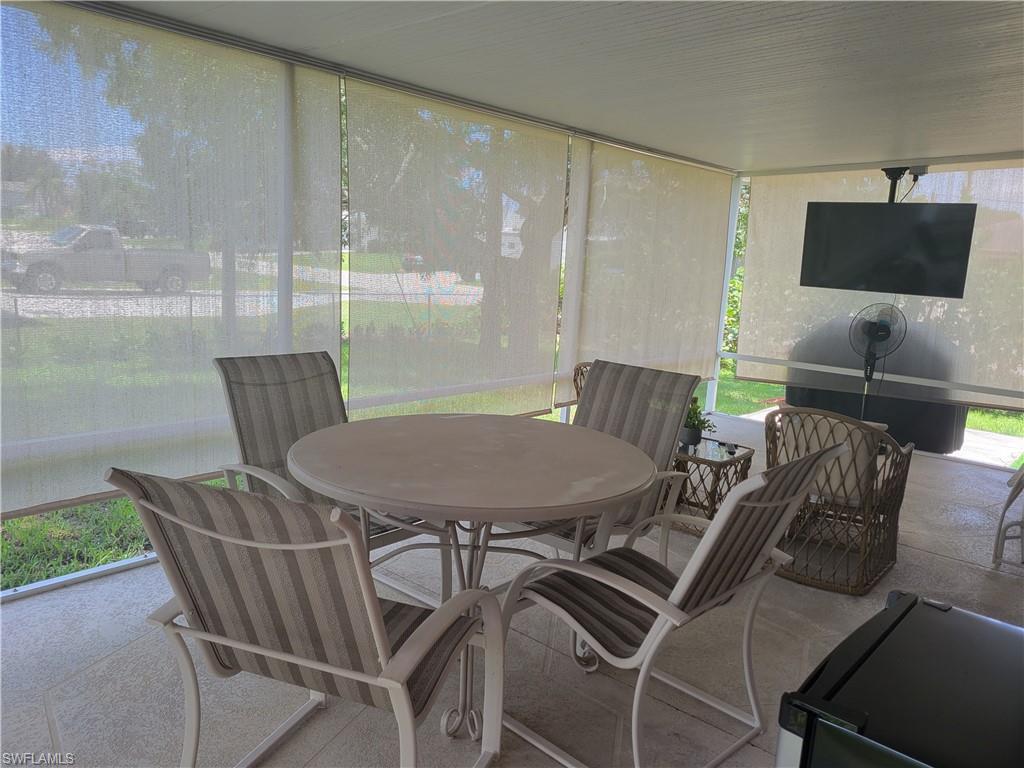 8518 Morris Road Fort Myers, FL 33967 - Photo 16 of 18 a view of a dining room with furniture wooden floor and a floor to ceiling window