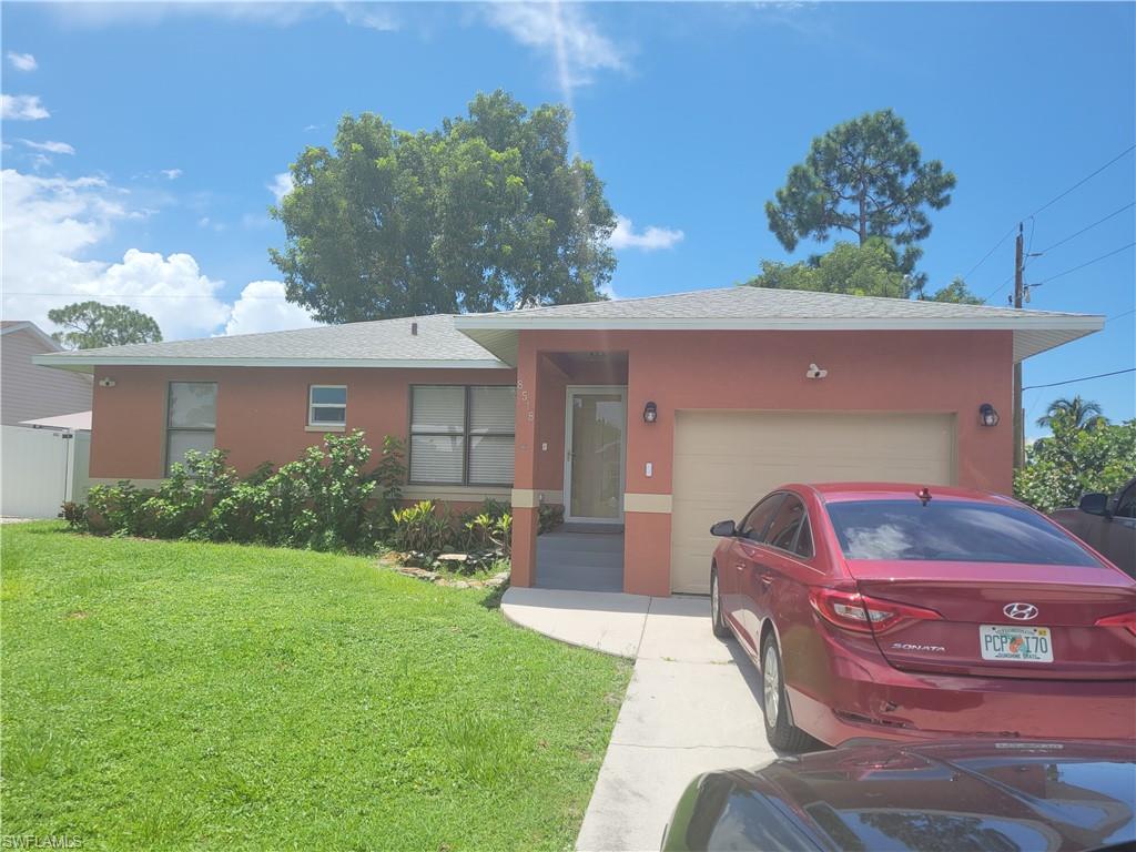8518 Morris Road Fort Myers, FL 33967 - Photo 2 of 18 a front view of a house with garden