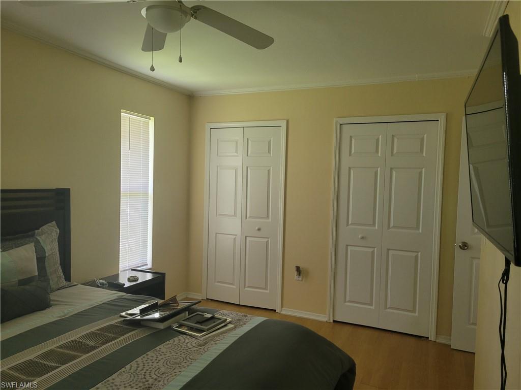8518 Morris Road Fort Myers, FL 33967 - Photo 7 of 18 a room with a flat screen tv and a fireplace