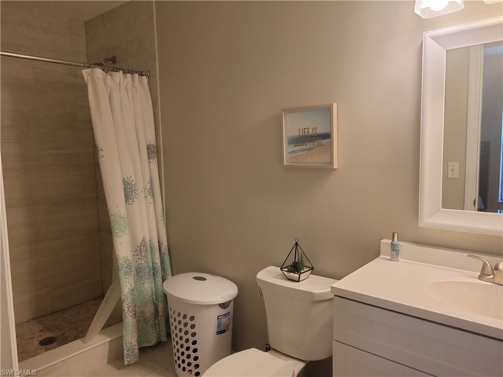 8518 Morris Road Fort Myers, FL 33967 - Photo 8 of 18 a bathroom with a toilet sink and a shower