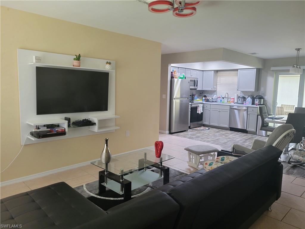 8518 Morris Road Fort Myers, FL 33967 - Photo 9 of 18 a living room with furniture and a flat screen tv