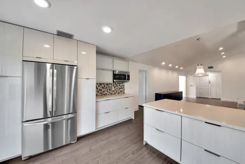 a kitchen with stainless steel appliances a refrigerator sink and microwave